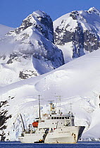 Exploration cruise ship ^Professor Molchanov^ in front of snow covered mountains, Antarctic Peninsula.