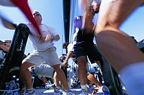 Winch grinders working at full speed in the cockpit, America's Cup.