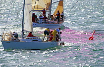Yacht crew pulling in a man who has fallen overboard, Key West Race Week, Florida, USA, 1996. (sequence 12)