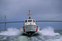 US Coastguards speeding under Newport Bridge, Rhode Island, USA.