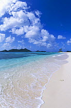 Calm turquoise waters lapping onto white sandy beach, Carriacou, Caribbean.