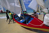 Locals launching one of the competing boats at the Grenada Sailing Festival, Grenada, Caribbean, 2005.
