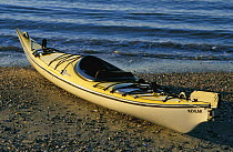 Kevlar kayak on a stony beach.
