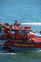 Fire rescue boat firing water from hoses, Newport, Rhode Island, USA.