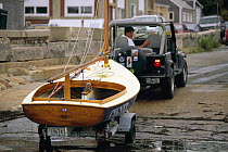 4x4 car hauling a beetlecat dinghy out of the water.