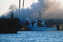 The US Coast Guard fighting a dock fire off Newport, Rhode Island, USA.
