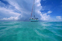 Sunsail charter yacht anchored in clear blue water off Abacos, Bahamas.