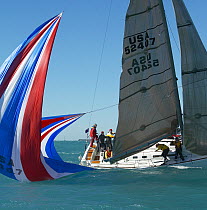 Spinnaker in the water tipping up the yacht during a spinnaker drop, Key West Race Week, Florida, 2005.