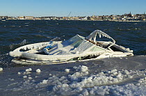 A small speedboat sunk by heavy ice and snow.