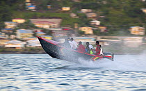 Fully laden speed boat travelling fast, Grenada Sailing Festival 2005, Grenada, Caribbean.
