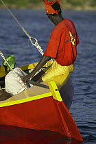 Local man sailing a traditional boat during Grenada Sailing Festival 2005, Grenada, Caribbean.