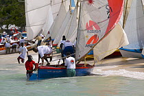 Locals preparing a traditional boat for racing during Grenada Sailing Festival 2005, Grenada, Caribbean.