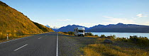 Campervan parked in a layby by a lakeside road, South Island, New Zealand.