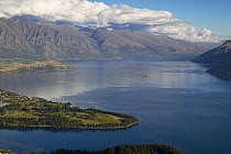 Parascending over a fjord, South Island, New Zealand.