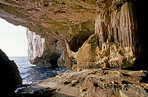 Small opening onto the sea from Neptune's Grotto, a deep marine cave in the sheer cliffs at Capo Caccia, Sardinia. ^^^A sightseeing tour to the grotto leaves regularly from the town of Alghero.