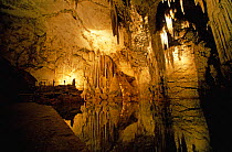 Stalagmites and stalactites lit in Neptune's Grotto, a deep marine cave in the sheer cliffs at Capo Caccia, Sardinia. ^^^A sightseeing tour to the grotto leaves regularly from the town of Alghero.