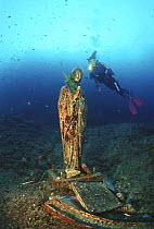 Diver with bronze statue of the Madonna at 12 metres, off the coast of the Sorrento Peninsula in southern Italy. ^^^The statue was the subject of a local religious feast and was placed there by devout...