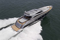Luxury 78ft Alfamarine motor yacht planing through the water at speed. Tirrenian sea, off the coast of Rome, Italy.