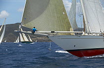 Schooner "Windrose" with bowman on the spinnaker pole, racing at Antigua Classic Yacht Regatta 2005, Caribbean.