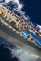 Looking down the forestay of J-Class "Ranger", with the crew seated along the upside gunwale during Antigua Classic Yacht Regatta 2005, Caribbean. Property Released.