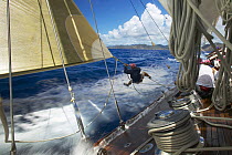 Crew member tripping the spinnaker during a race aboard J-Class "Velsheda" at Antigua Classic Yacht Regatta 2005, Caribbean. Property Released.