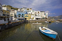 Small outboard boat moored off the waterfront at Borgo Sant'Angelo, Ischia, Bay of Naples, Italy.