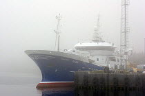 Early morning mist shrouds the pelagic trawler Lunar Bow at Peterhead harbours, Scotland.May 2005.