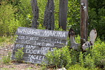 A shabby wooden sign advertising Whidden's Marina, Florida, USA. The marina is located in Boca Grande, the Tarpon capital of the world. ^^^Whidden's Marina on First Street East was founded by Sam Whid...