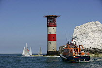 Yachts competing in the JPMorgan Round the Island Race passing The Needles Lighthouse with a lifeboat in the foreground, Isle of Wight, England, UK. 18th June 2005. ^^^Super-maxi "Maximus" took line h...