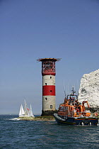 Yachts competing in the JPMorgan Round the Island Race passing The Needles Lighthouse with a lifeboat in the foreground, Isle of Wight, England, UK. 18th June 2005. ^^^Super-maxi "Maximus" took line h...