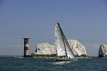 Yacht competing in the JPMorgan Round the Island Race with The Needles Lighthouse beyond, Isle of Wight, England, UK, 18th June 2005. ^^^Super-maxi "Maximus" took line honours finishing the 50 mile co...