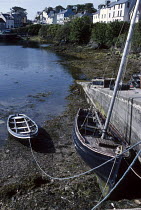 Tender and sailing boat tied to concrete slipway, Pokan, Roundstone, Connemara, Ireland.