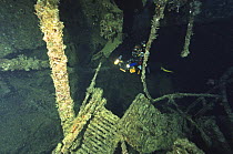 Diver exploring the wreck of the SS Thistlegorm, located in the Straits of Gubal, Northern Red Sea. She was sunk by German bomber planes in World War II ^^^and has lain at the bottom of the sea for ov...