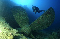 Diver and propeller on the wreck of the SS "Thistlegorm", located in the Straits of Gubal, Northern Red Sea. She was sunk by German bomber planes in World War II ^^^and has lain at the bottom of the s...