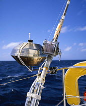 Fishing reel and barbecue on the stern pushpit of a cruising yacht.