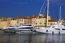 Luxury motorboats and yacht moored in the  harbour at St Tropez, France.