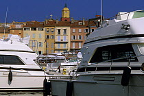Boats and houses on waterfront at St Tropez, South of France.