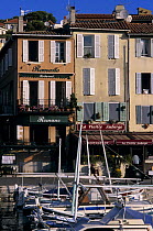 Boats and shop fronts in the old port of Cassis, South of France.