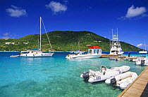 Sports fishing boats tied up alongside pier and fuel station at Marina Cay, British Virgin Islands (BVI).