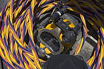 Commercial diver's hard hat helmet and suface supply hoses, Oahu, Hawaii.
