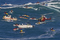 Helicopter filming tow-in surfing at Peahi (Jaws) off Maui, Hawaii.