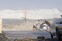 Tow-in surfers attempting to launch jetski at Maliko Gulch for surfing at Peahi (Jaws) off Maui, Hawaii.