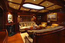 Lower saloon of 180ft superyacht "Adele" boasts comfy sofas and a working fire place.^^^ The 180-foot luxury ketch was designed by Andre Hoek and built by the famous Vitters Shipyard in Holland. It is...