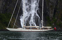 Superyacht "Adele" exploring the Norwegian Fjords in the Sognefjorde area, during week 25 of her maiden voyage.^^^ A waterfall forms a dramatic backdrop. Adele is a 180-foot Andre Hoek designed yacht...