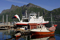 Ferry with its bow doors open allows passengers to embark, at her berth in the Lofoten Islands, Norway. ^^^