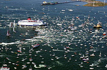 Fleet move away from the start line followed by hundreds of spectator boats in Gothenburg Sweden in the Volvo Ocean Race restart, June 8, 2001-2002.