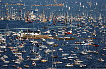 Fleet move away from the start line followed by hundreds of spectator boats in Gothenburg Sweden in the Volvo Ocean Race restart, June 8, 2001-2002.