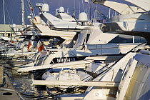 Row of motoryachts moored in a marina. Porto di Roma, Fiumicino, Rome, Italy.