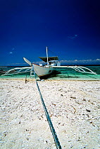 Bancas, a typical fishing boat of this area, pulled up on a beach at Balicasag Island (Bohol), Philippines.