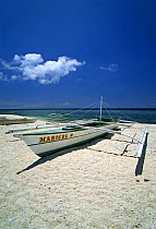 Local Banca boat pulled up on a coral beach on the small island of Balicasag Island, Bohol, Philippines.